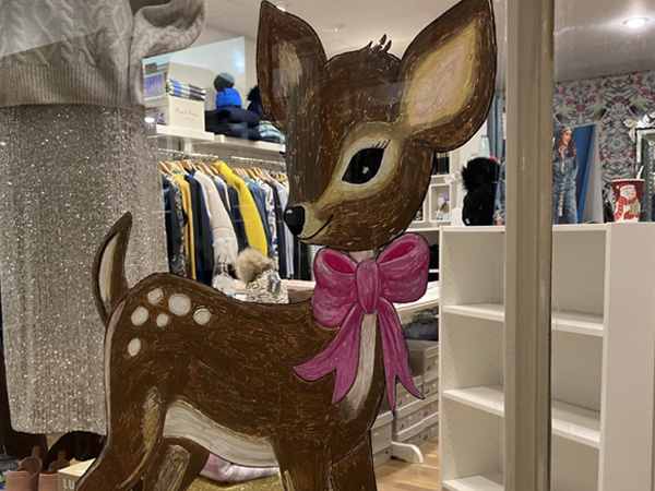 Painted fawn with a pink bow in a shop display
